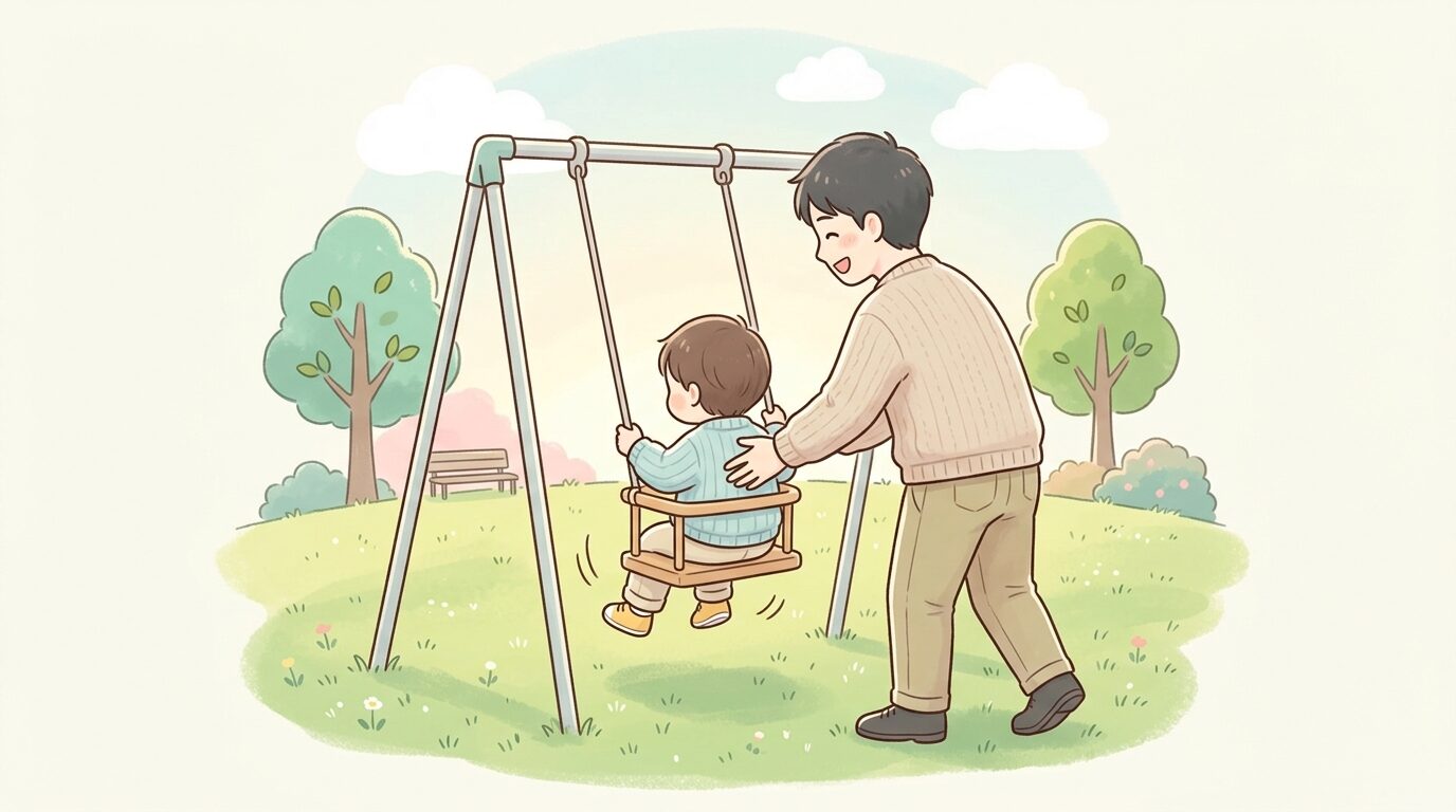 公園の芝生の上で、父親が子どものブランコを優しく後ろから押している親子の後ろ姿